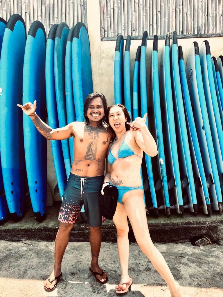 Smiling guests with surfboards