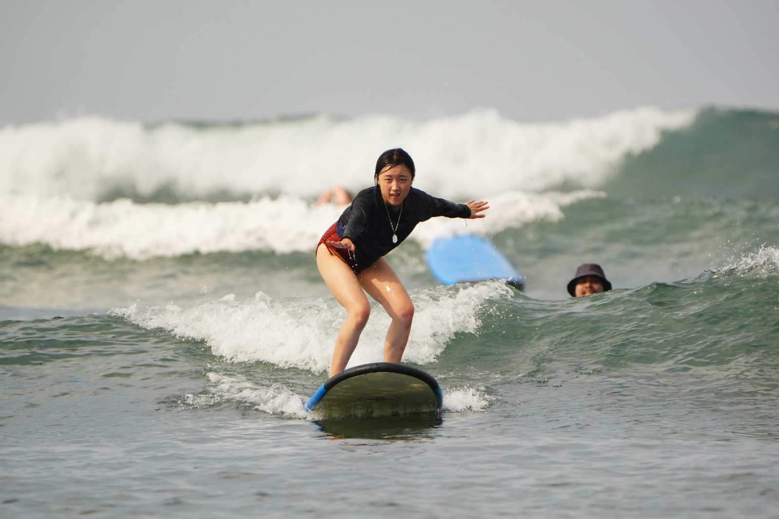 A guest standing up on a wave in Bali
